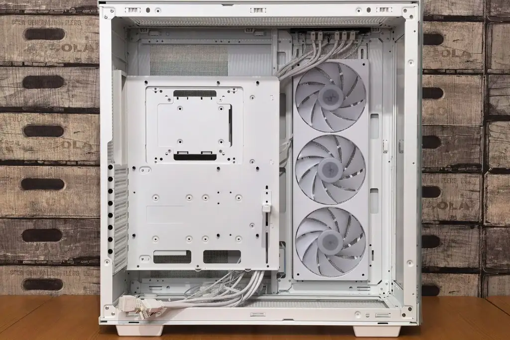 An open white gaming PC case with three cooling fans