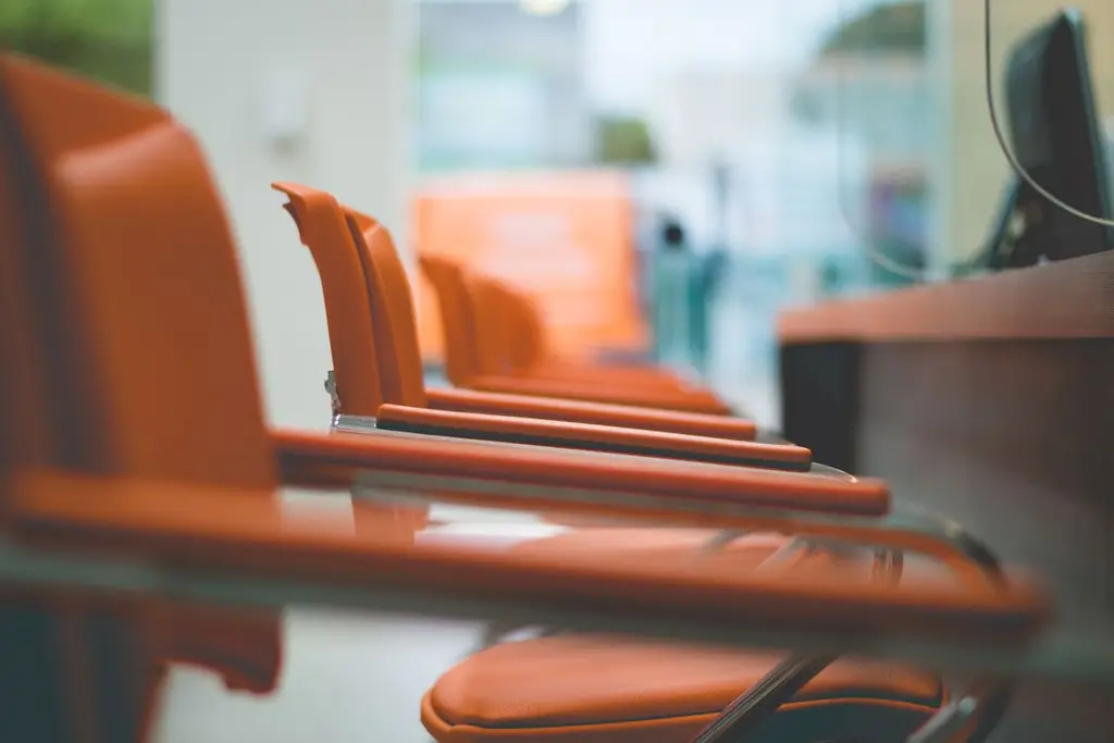 Orange office chairs in a row with a blurred background